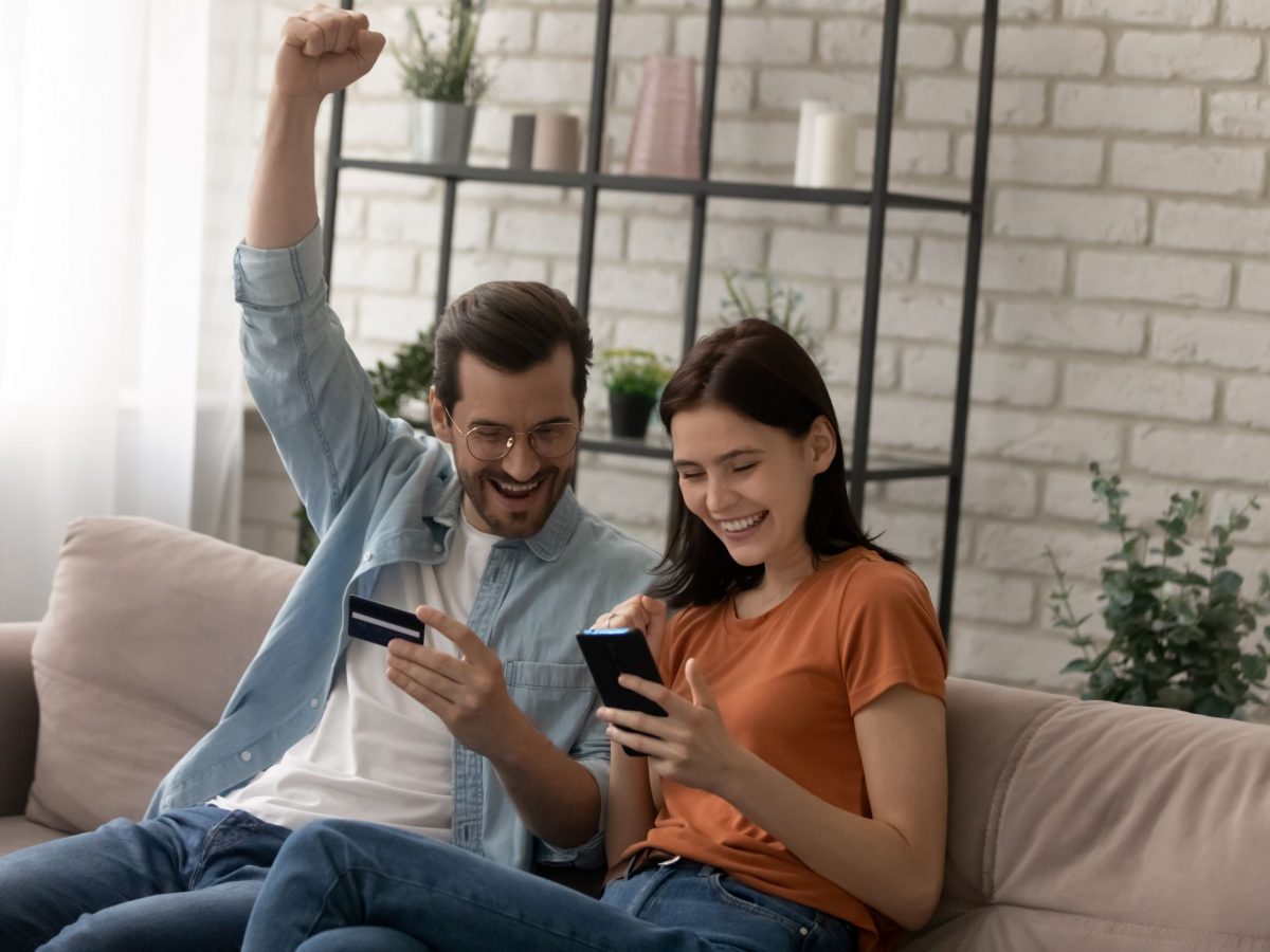Man and woman staring at phones, happy