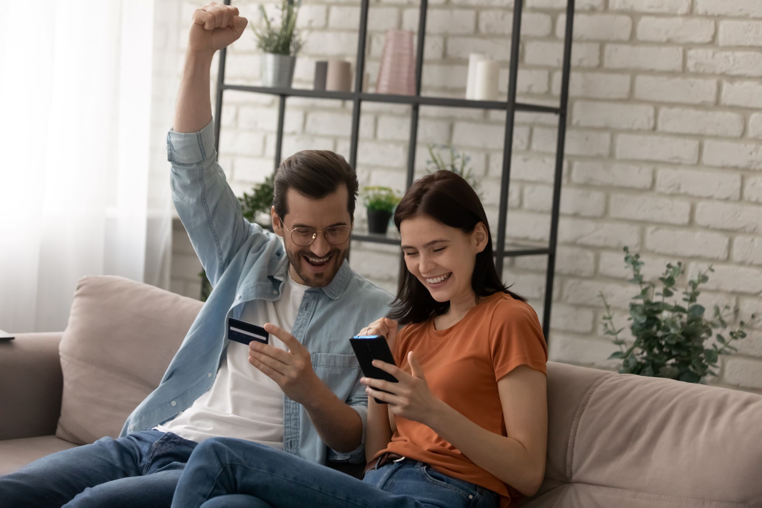 Man and woman staring at phones, happy