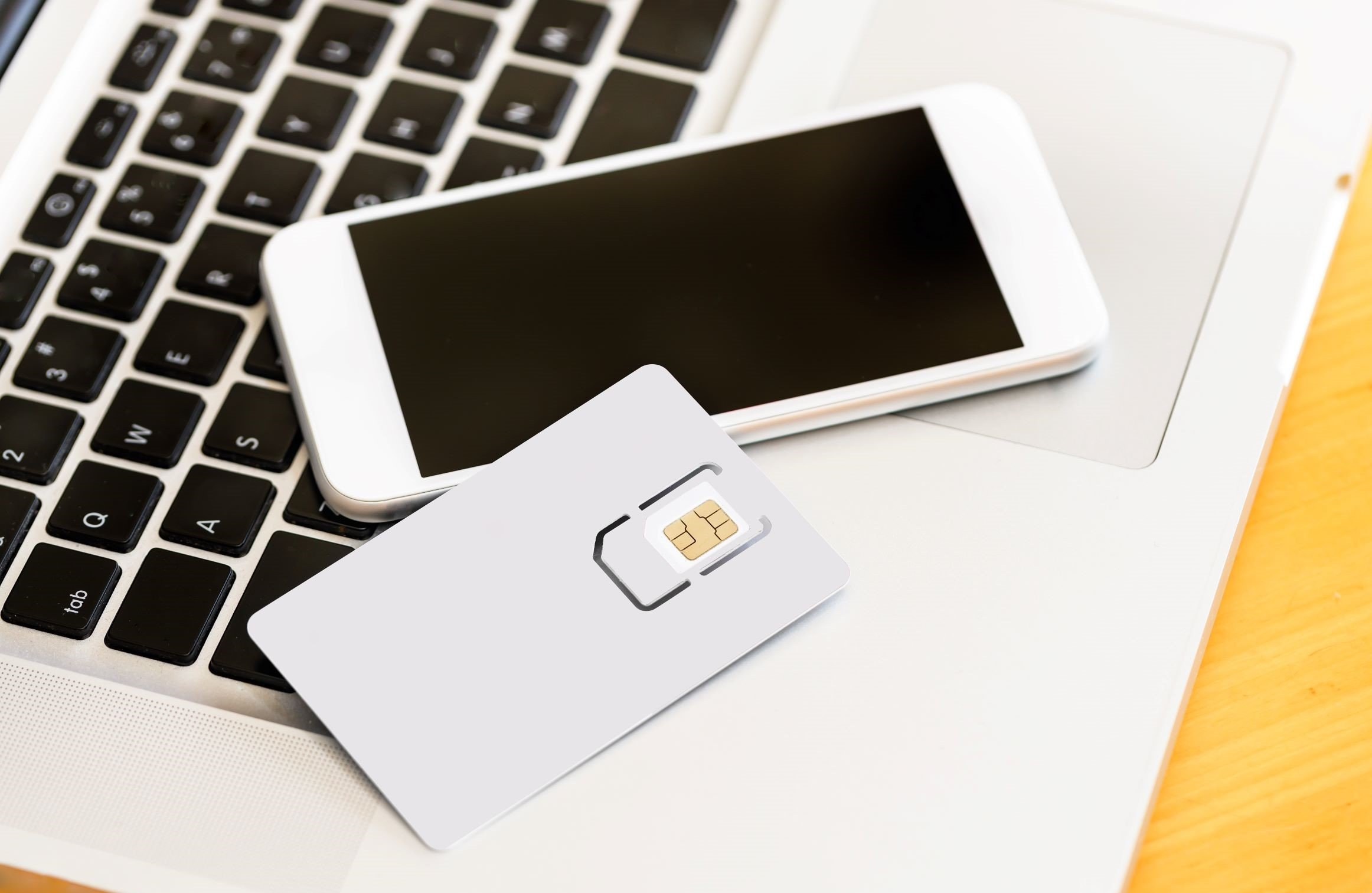 iPhone and SIM card on a keyboard